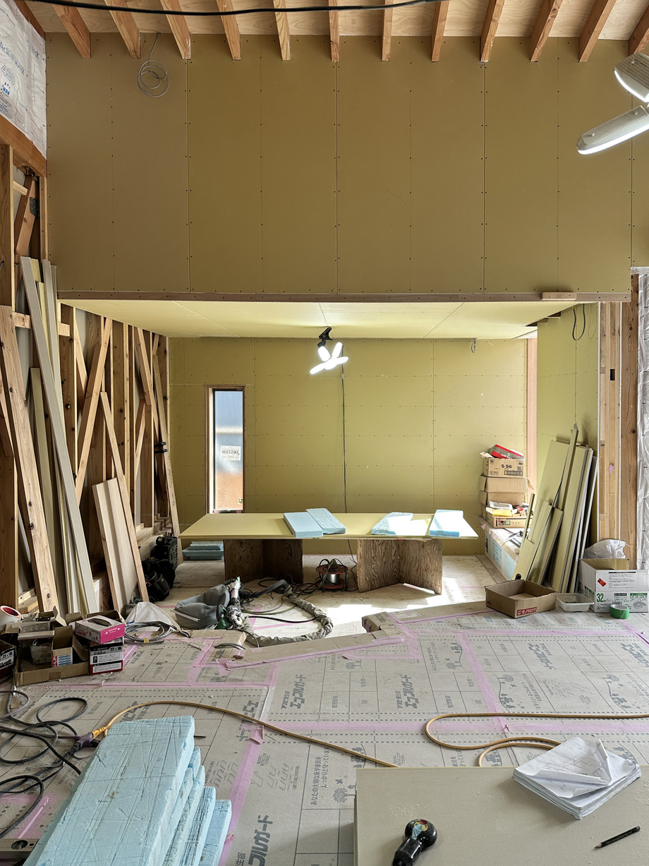 袖ケ浦市の平屋「紅の家」リビング施工中。ロフト下の空間に石膏ボードを張った状態の内部写真。
