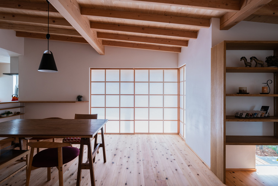 鎌ケ谷市「鎌ケ谷の家D」　木製全開サッシの障子を閉めた状態　柔らかい自然光が室内に拡散されている　化粧垂木と漆喰の部屋