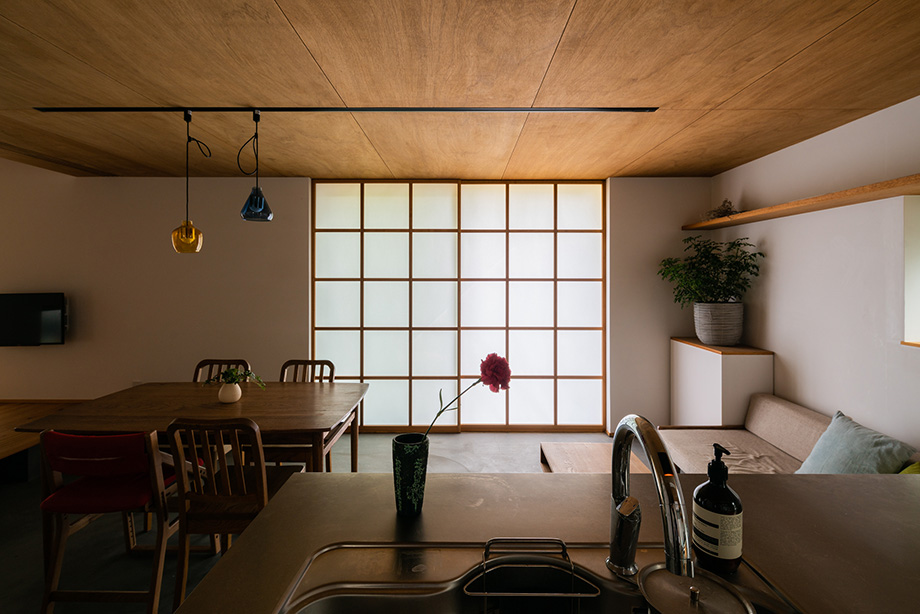葉山「土間から四季を。呼吸する家」キッチンから土間のダイニングの大きな引込障子を見ている
